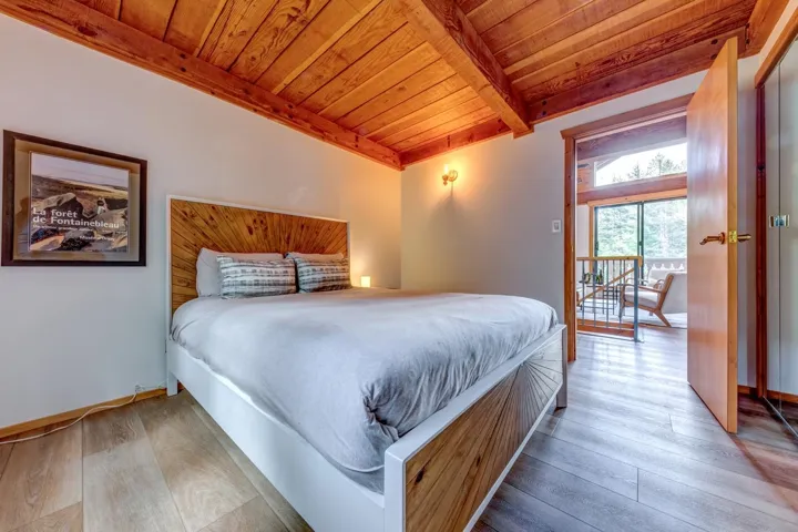 Bedroom featuring wooden ceiling, hardwood / wood-style flooring, and beamed ceiling