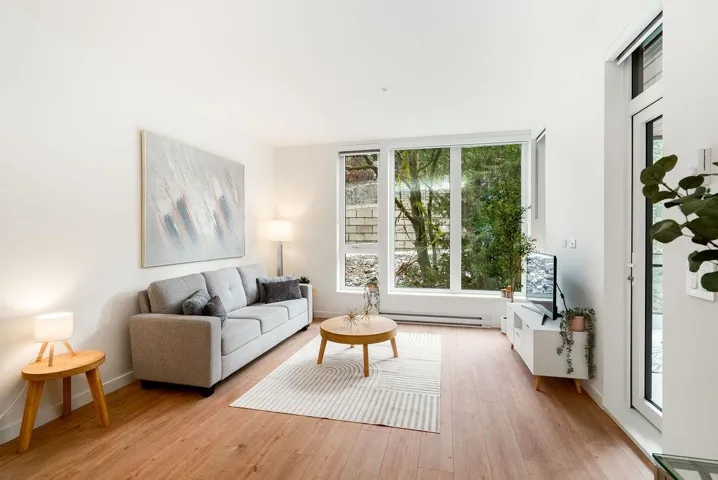 Living room with light wood-style floors and a baseboard radiator