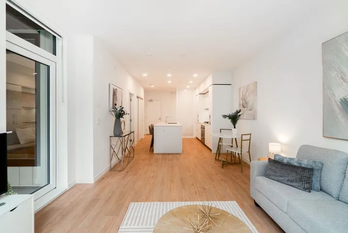 Living room featuring light wood-type flooring and recessed lighting