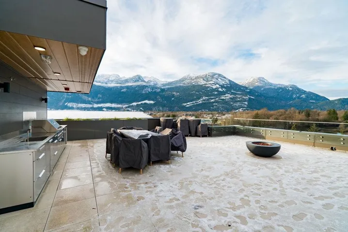 View of patio with a mountain view, area for grilling, and a fire pit