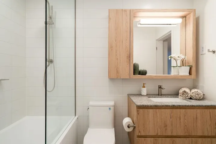 Bathroom with tile walls, vanity, and shower / tub combination