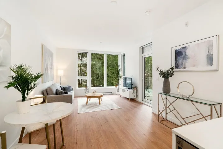 Living room with healthy amount of natural light and light wood finished floors