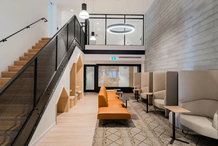 Common area with a high ceiling and co-working space