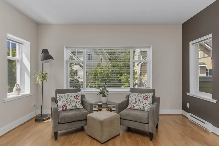 Light wood-finish flooring complements neutral wall tones