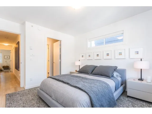 Bedroom with multiple windows and light wood-type flooring