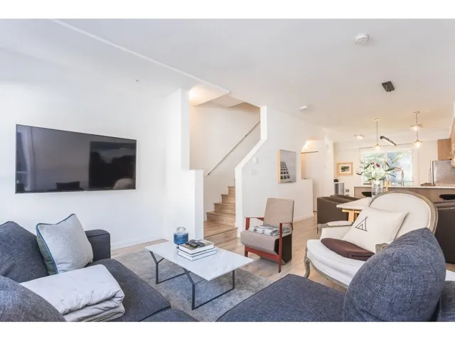 Living area with light wood-type flooring and stairs