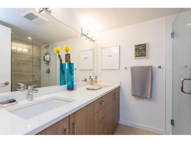 Bathroom with a stall shower and double vanity