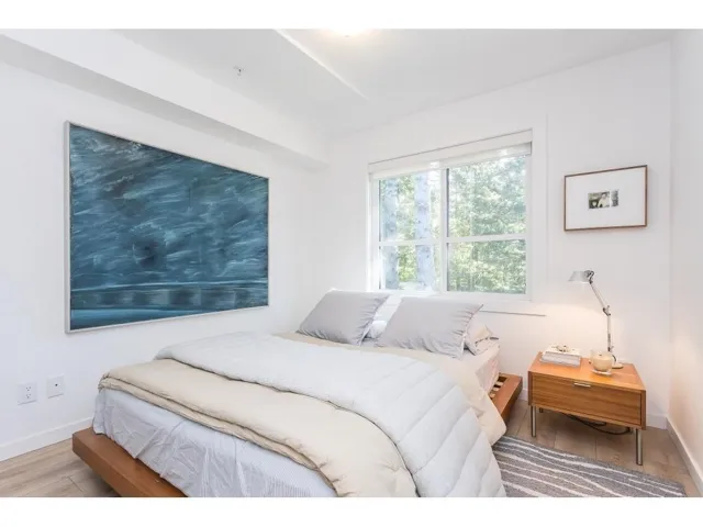 Bedroom featuring baseboards and wood finished floors