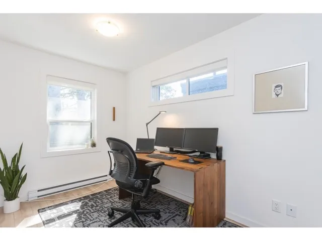 Office space with a baseboard radiator and light wood-type flooring