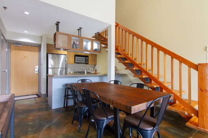 Dining area with stairway, recessed lighting, and finished concrete floors