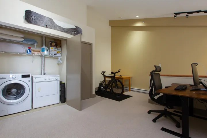 Laundry room featuring carpet flooring, independent washer and dryer, and laundry area