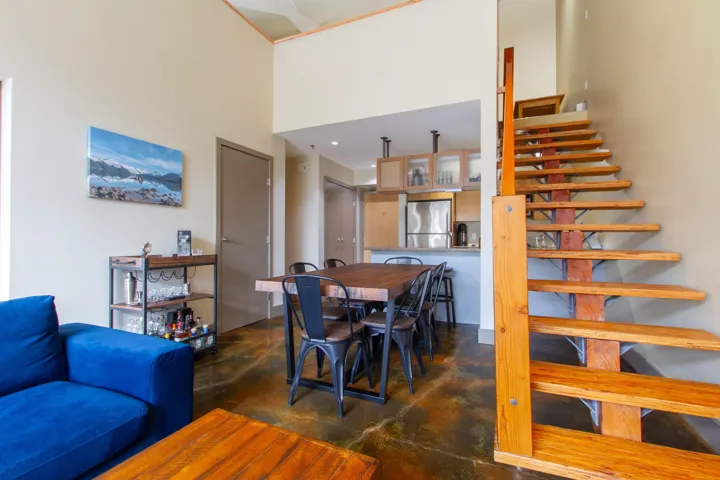 Dining space featuring finished concrete flooring and a towering ceiling