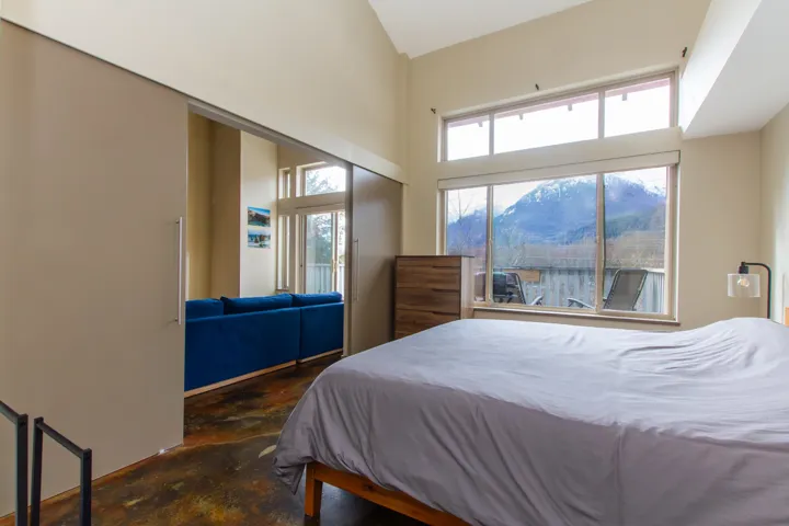 Bedroom featuring a closet, a mountain view, and concrete flooring