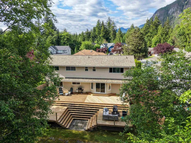 Expansive multi-level wood deck with integrated terraced seating, providing abundant outdoor living space
