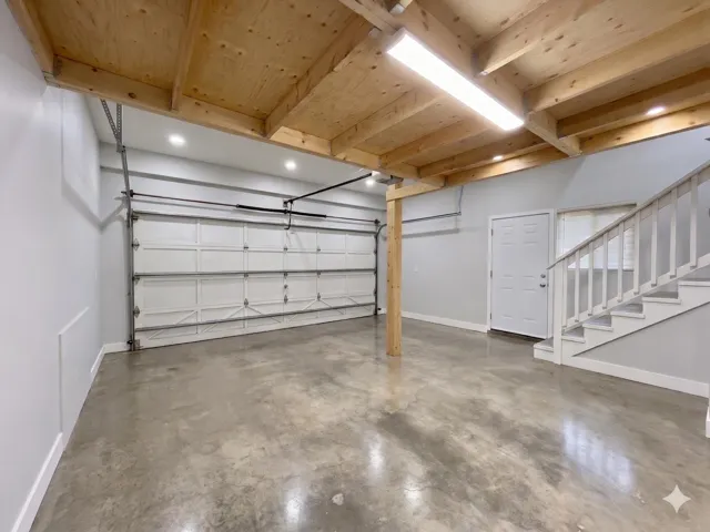 Garage with baseboards and recessed lighting