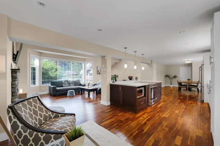 Open concept living area featuring wood-finish flooring throughout