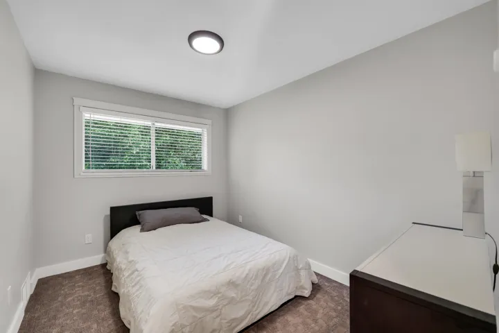 Neutral painted walls complemented by white trim and a window with blinds