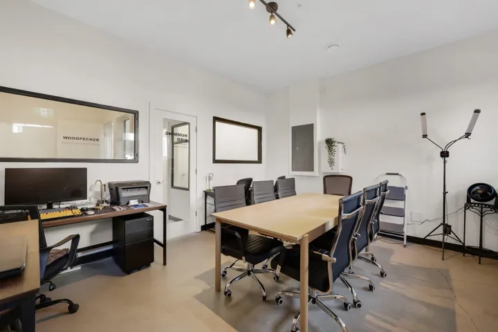 Open-plan commercial space featuring light-toned flooring and white walls