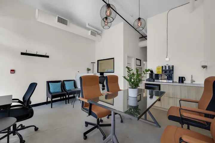 Polished concrete flooring with exposed ductwork and pendant lighting