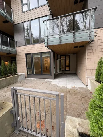 View of exterior entry with a patio