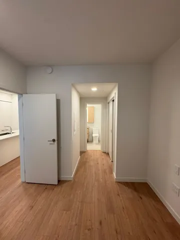 Corridor with light wood finished floors and baseboards