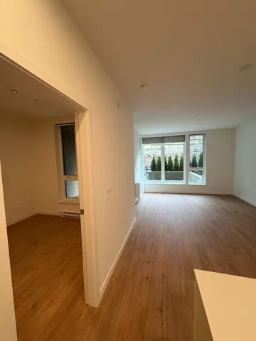 Empty room with light wood-style floors and a baseboard radiator