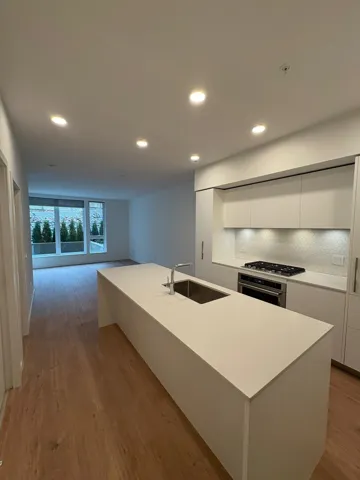 Kitchen with white cabinetry, modern cabinets, stainless steel appliances, recessed lighting, and a kitchen island with sink