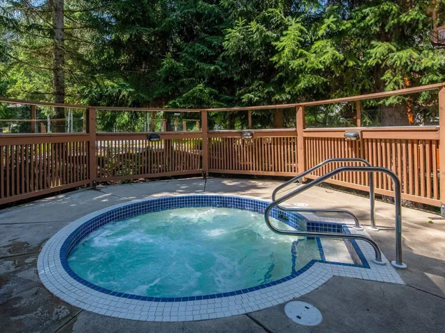 View of pool with a community hot tub and a patio