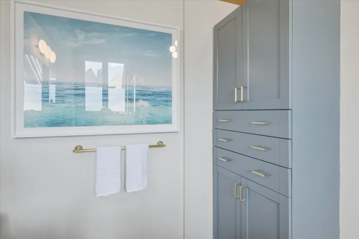 Built-in cabinetry featuring a soft blue finish and brushed nickel hardware