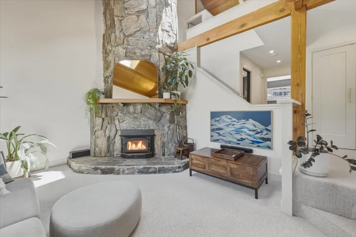 Stone-clad fireplace with a hearth and wood-burning insert