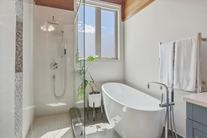Freestanding soaking tub with floor-mounted faucet