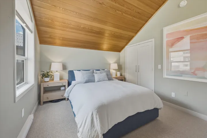 Vaulted wood-paneled ceiling with recessed lighting