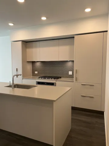 Kitchen with decorative backsplash, white cabinetry, recessed lighting, modern cabinets, and dark wood-type flooring