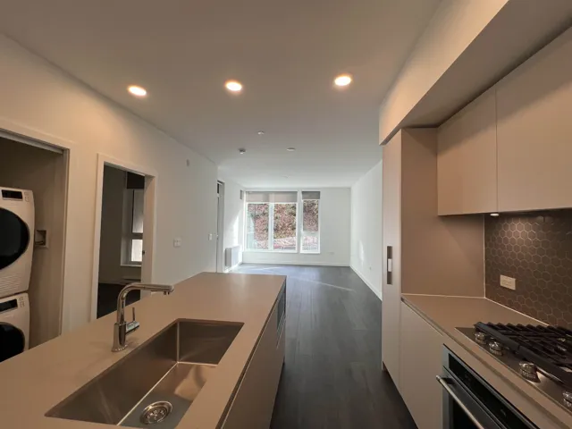 Kitchen with appliances with stainless steel finishes, recessed lighting, dark wood-style floors, modern cabinets, and open floor plan