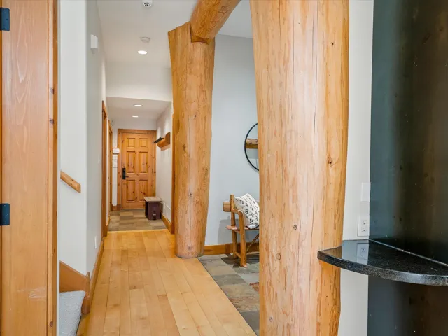 Corridor featuring hardwood / wood-style floors and recessed lighting