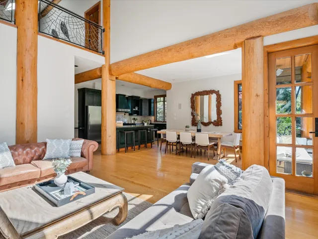 Living area featuring light wood-type flooring and a towering ceiling