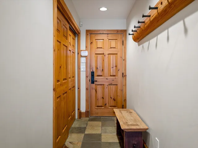 Doorway with recessed lighting and stone finish flooring