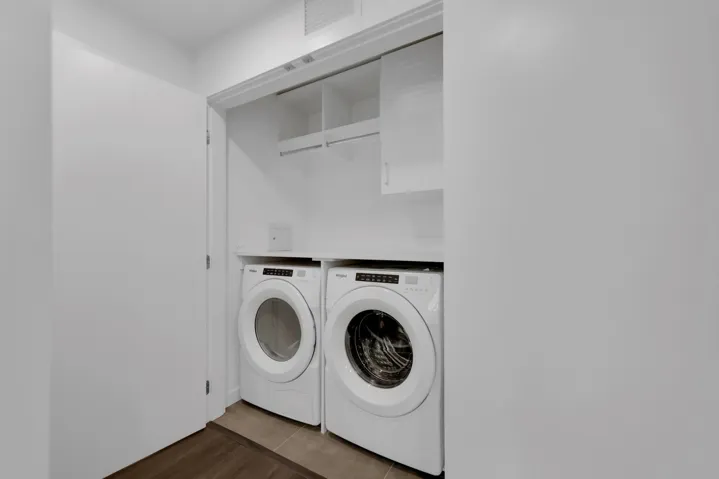 Washroom with washer and dryer and tile patterned flooring