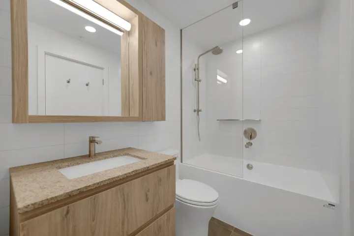 Bathroom featuring tile walls, vanity, shower / tub combination, recessed lighting, and tile patterned floors
