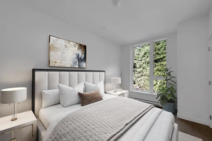 Bedroom with wood finished floors and baseboard heating