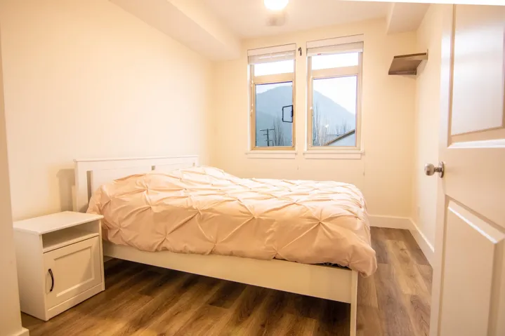 Bedroom featuring wood finished floors and baseboards