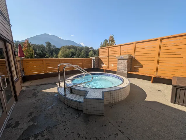 View of swimming pool featuring an in-ground hot tub, a mountain view, and a patio area