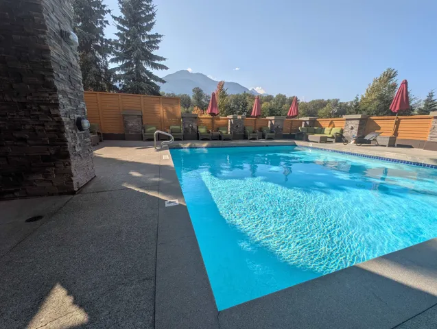 View of pool with a mountain view and a patio
