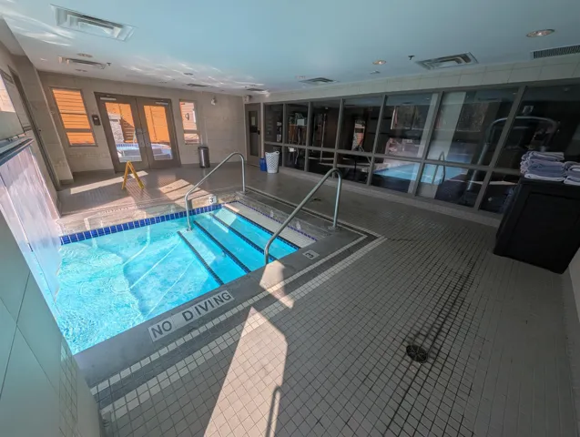 Indoor community pool featuring french doors