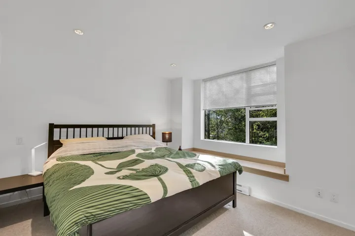 Carpeted bedroom with recessed lighting and a baseboard radiator