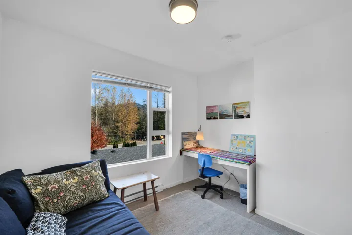 Carpeted home office featuring baseboards and a baseboard radiator