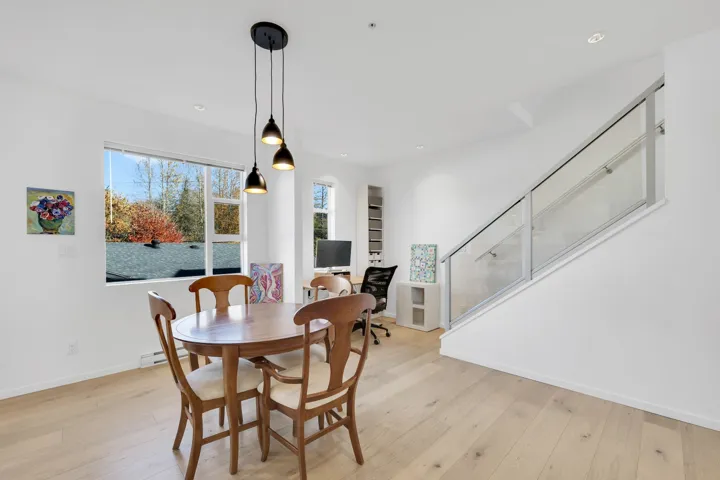 Dining area with light wood-style floors, recessed lighting, and stairway