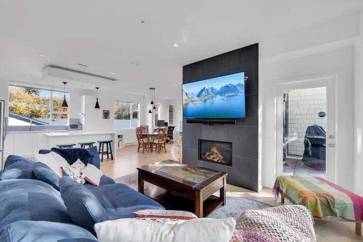 Living area featuring wood finished floors, a fireplace, and recessed lighting