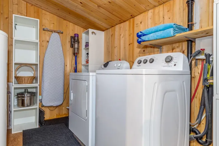 Utility area featuring a top-load washing machine and front-load dryer