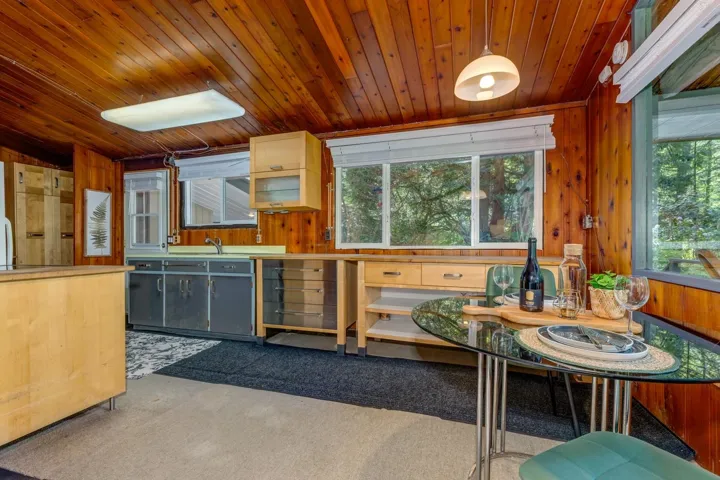 Kitchen space featuring wood-paneled walls and ceiling